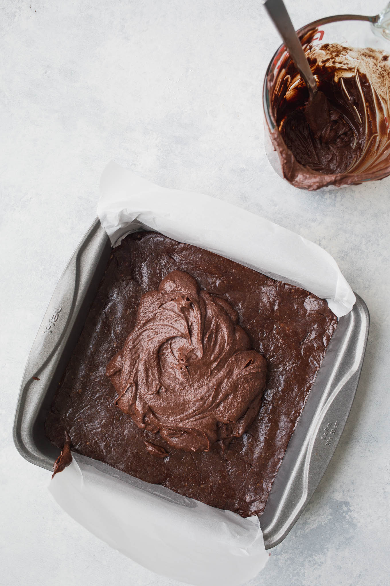 No-bake, raw chocolate brownies made with a layer of hemp seeds, walnuts, cocoa, and dates, topped with a delicious chocolate ganache frosting. Gluten-free, vegan, and refined sugar-free. 
