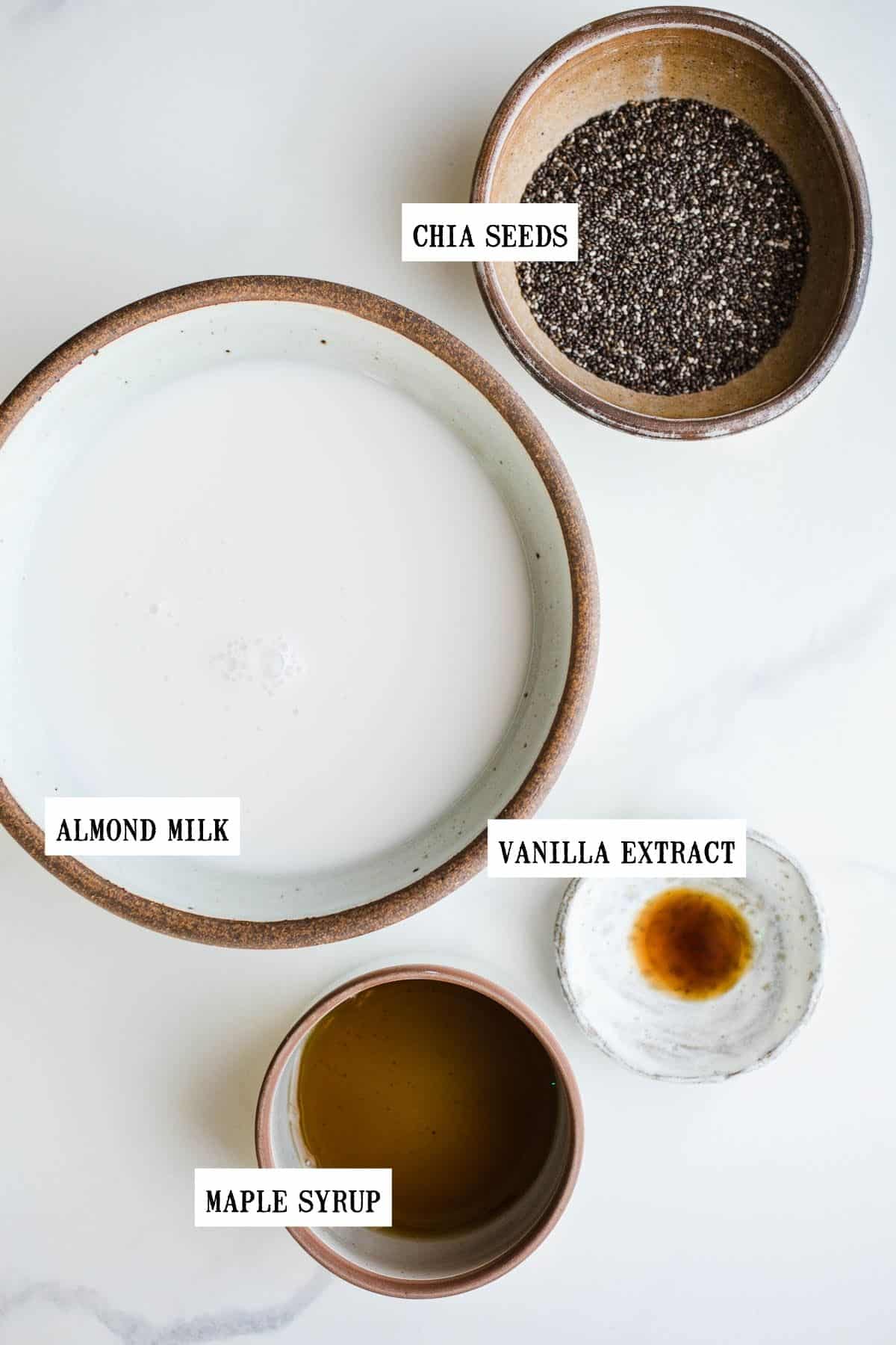 Ingredients for chia seed pudding separated into four bowls.
