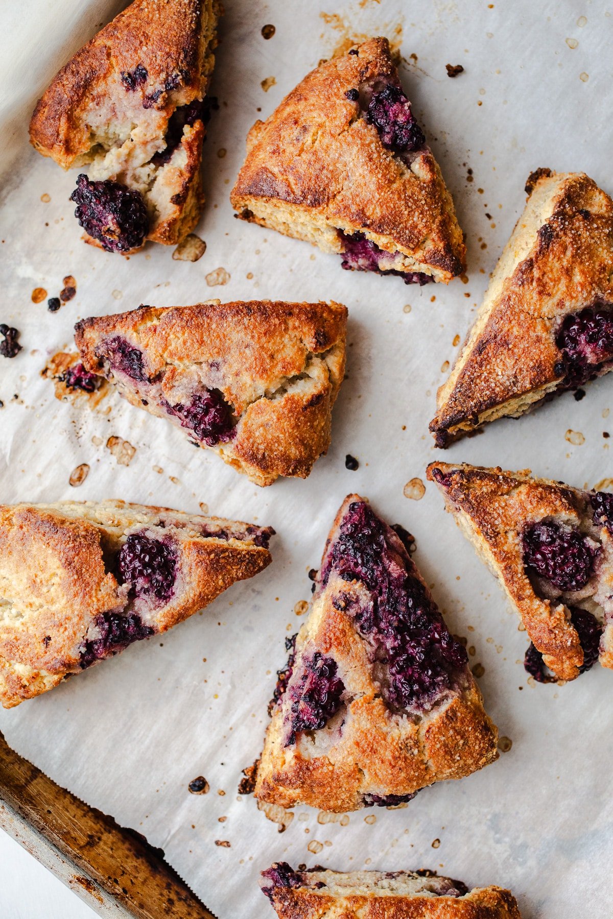 Blackberry scones on parchment paper.