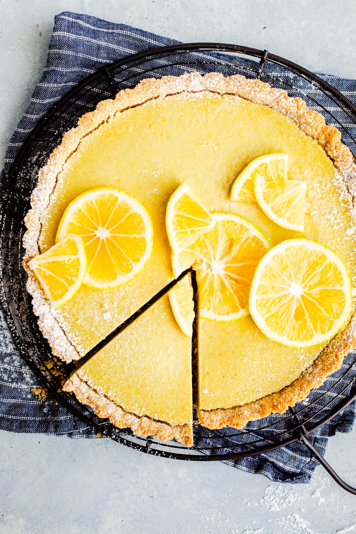 A lemon tart topped with lemon slices.