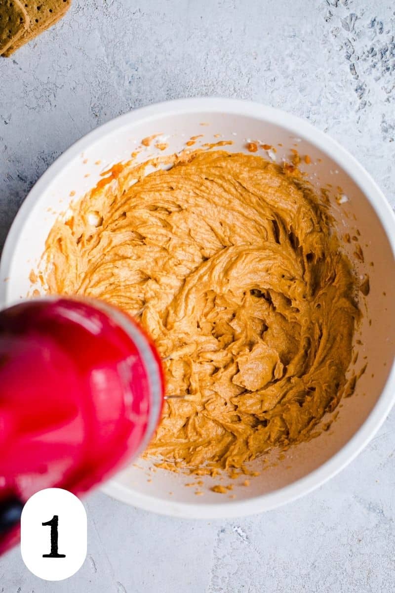 Pumpkin and cream cheese in a mixing bowl. 