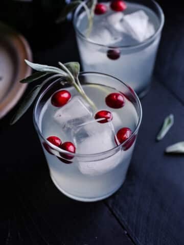A cocktail with sage and cranberries.
