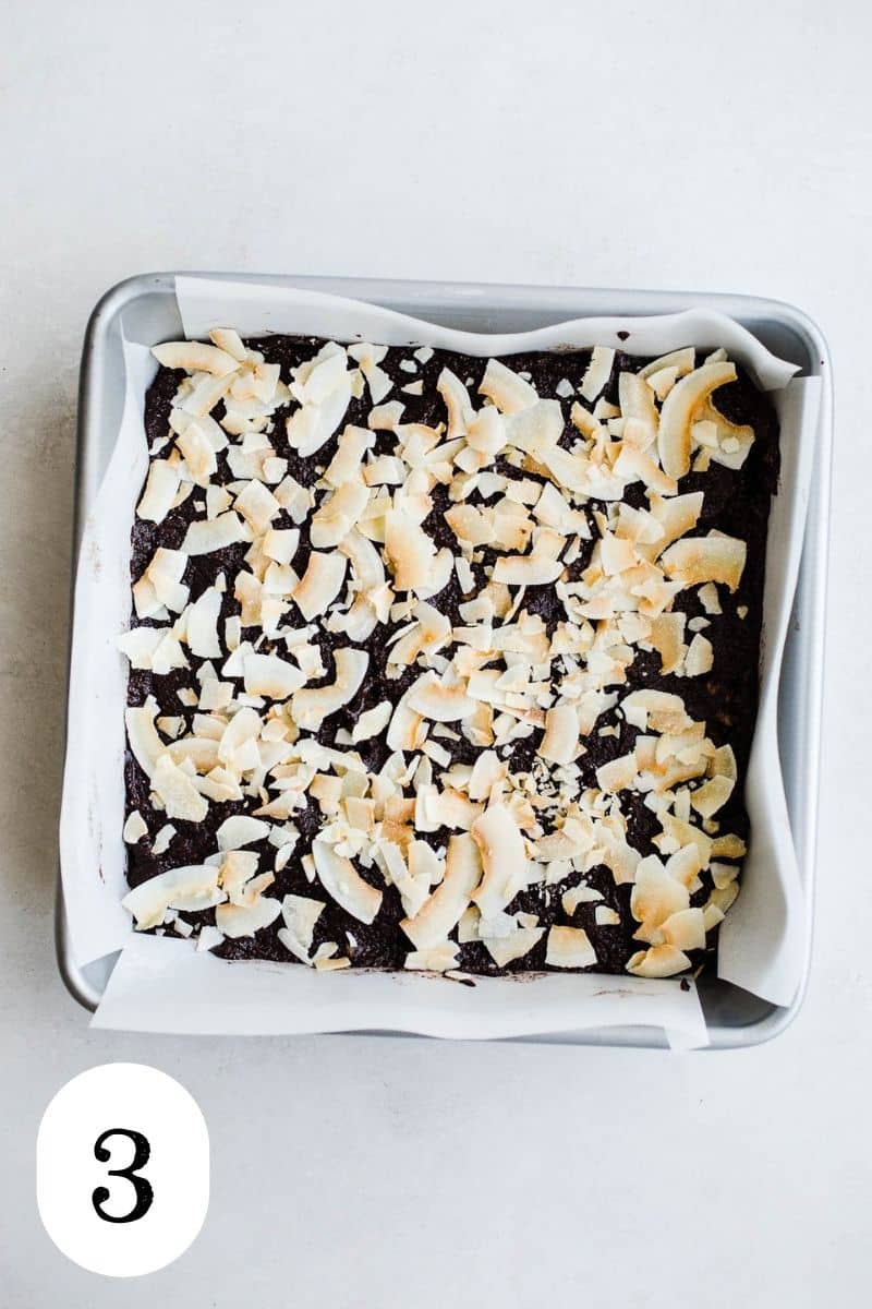 Unbaked coconut brownies in a baking pan.