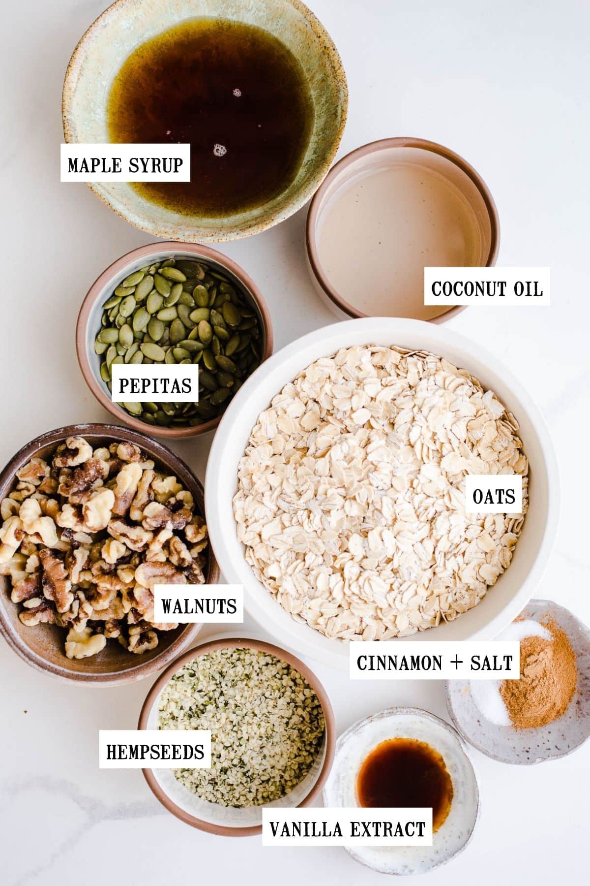 Ingredients to make granola in small bowls. 