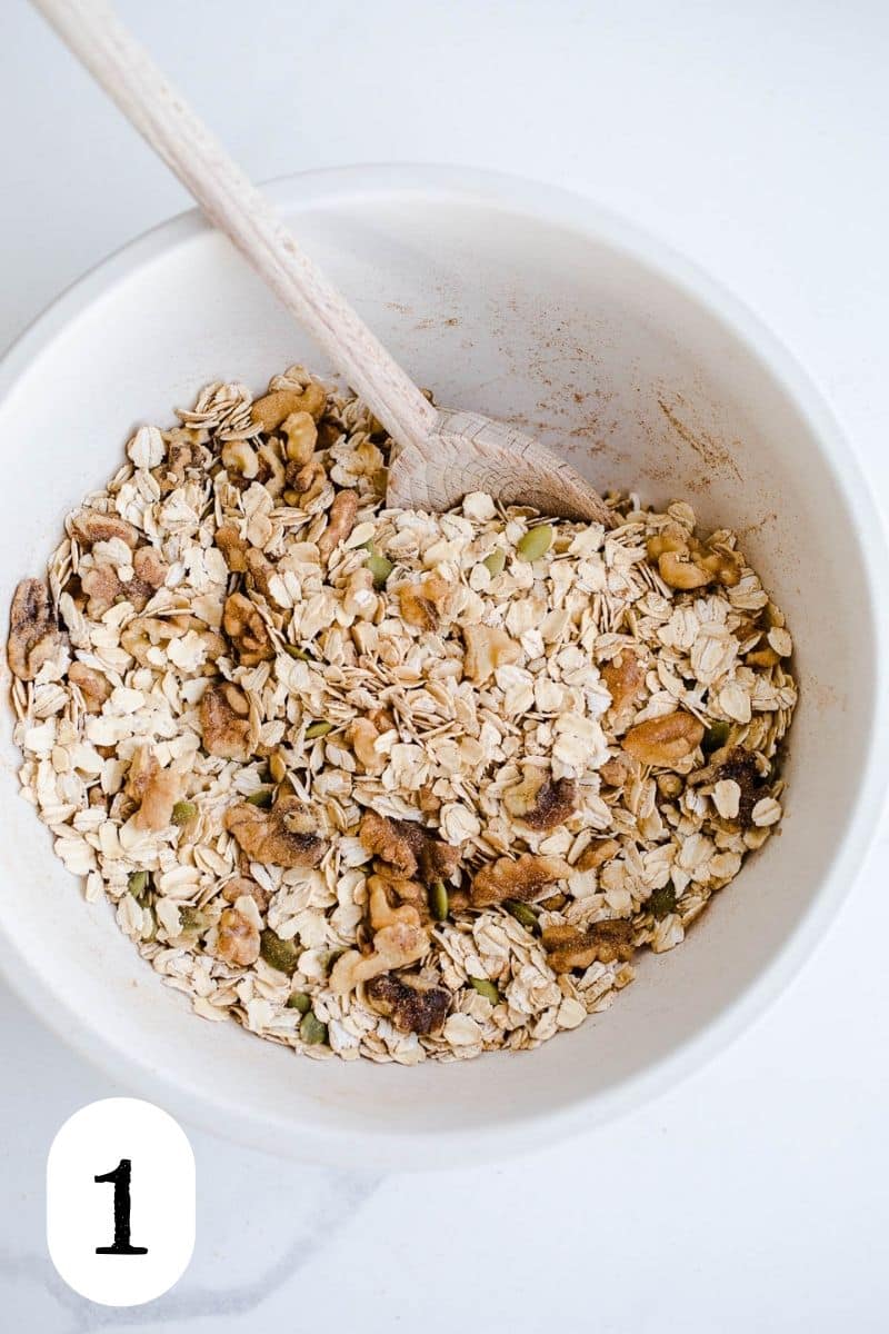 A bowl of oats, nuts, and seeds.