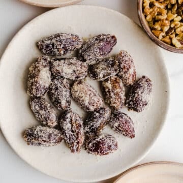 Sugared dates on a cream plate.