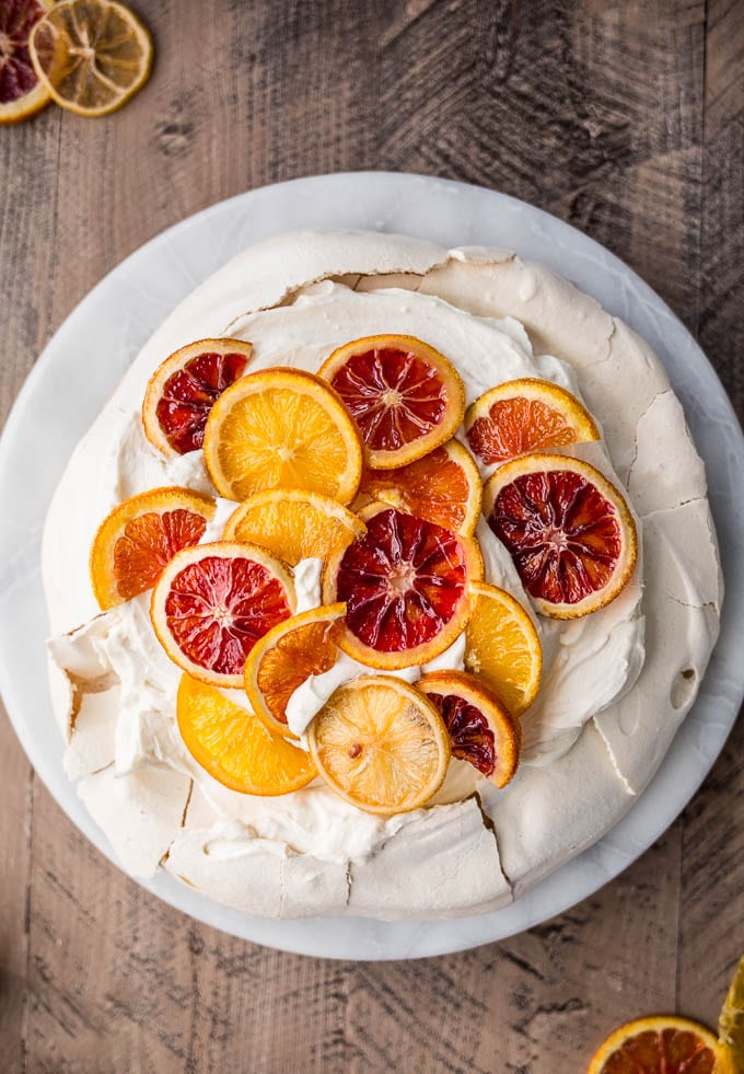 A pavlova topped with citrus.