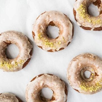 Glazed donuts topped with pistachios.