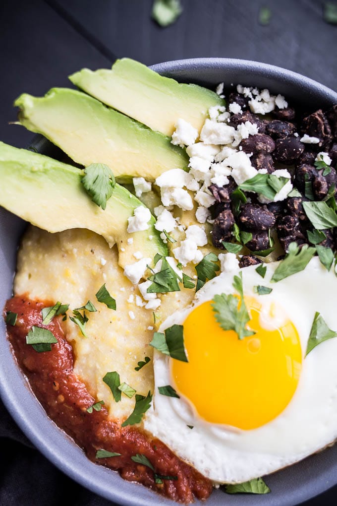 A bowl filled with polenta and topped with an egg.