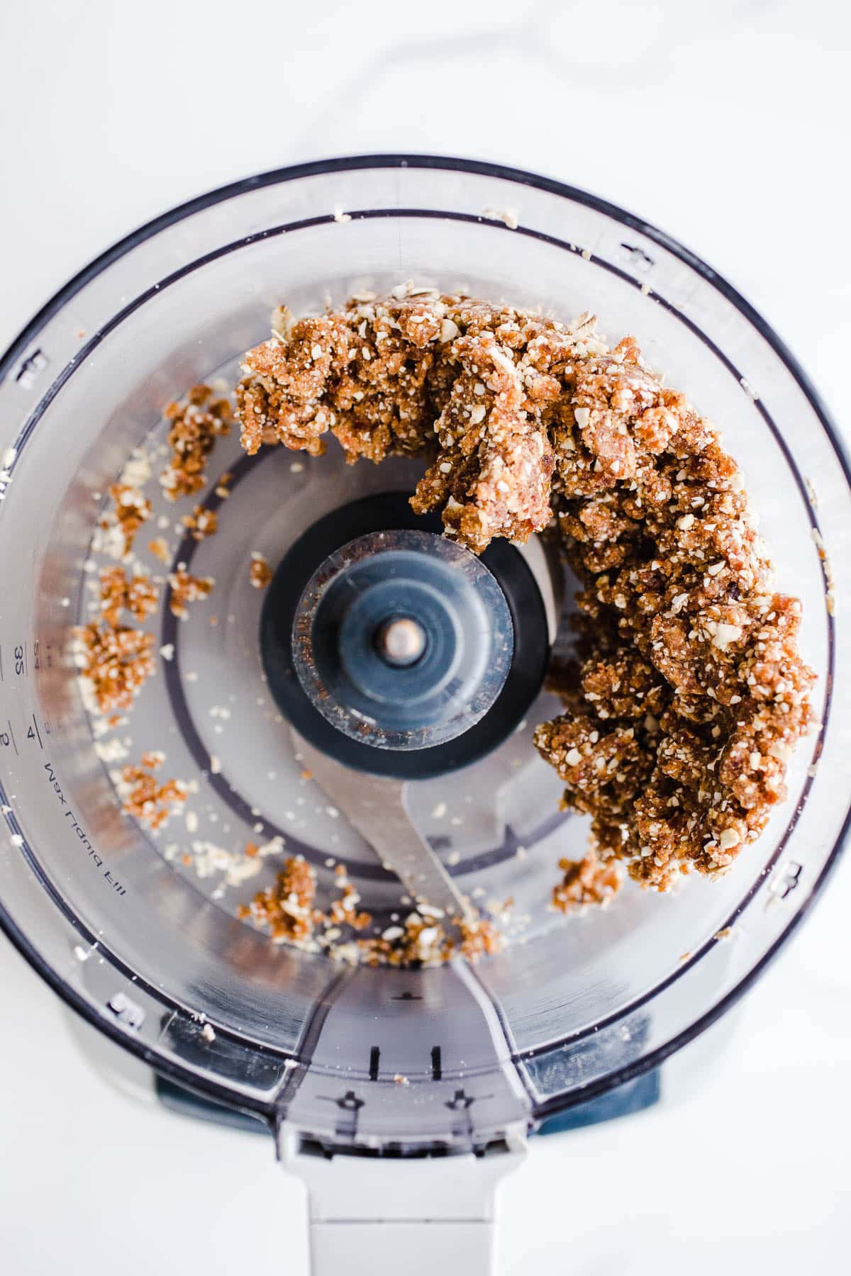 Cashews and dates in the bowl of a food processor.