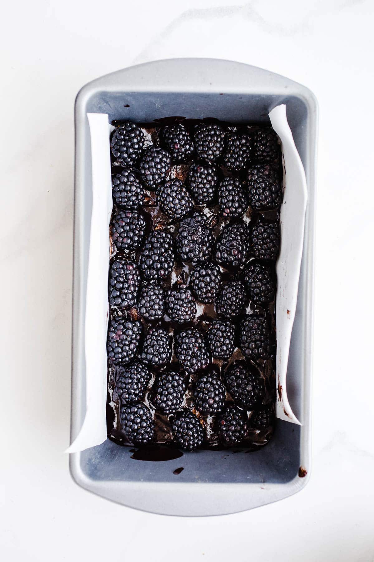 Blackberries pressed into chocolate in a loaf pan.