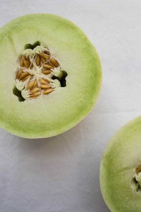 Fresh honeydew cut in half.