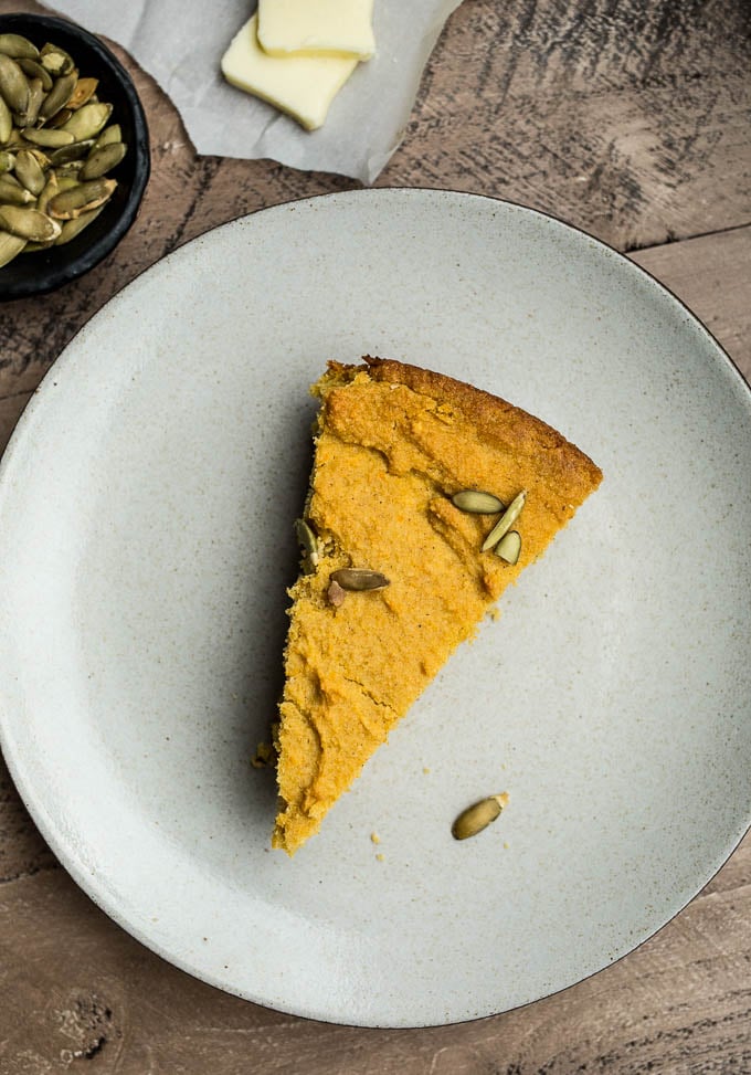 A slice of cornbread on a plate. 