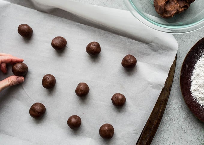 chocolate cookie balls on baking sheet