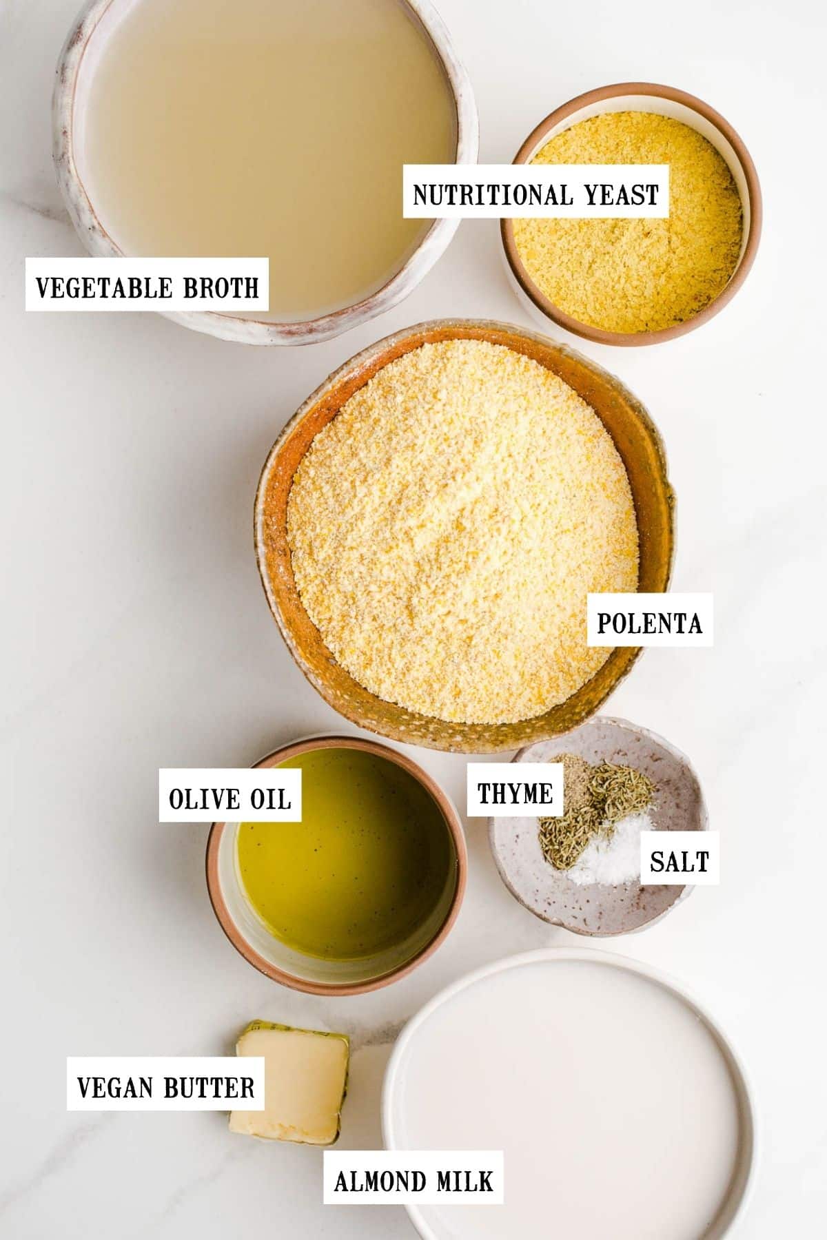 Ingredients to make polenta fries in bowls of different sizes.