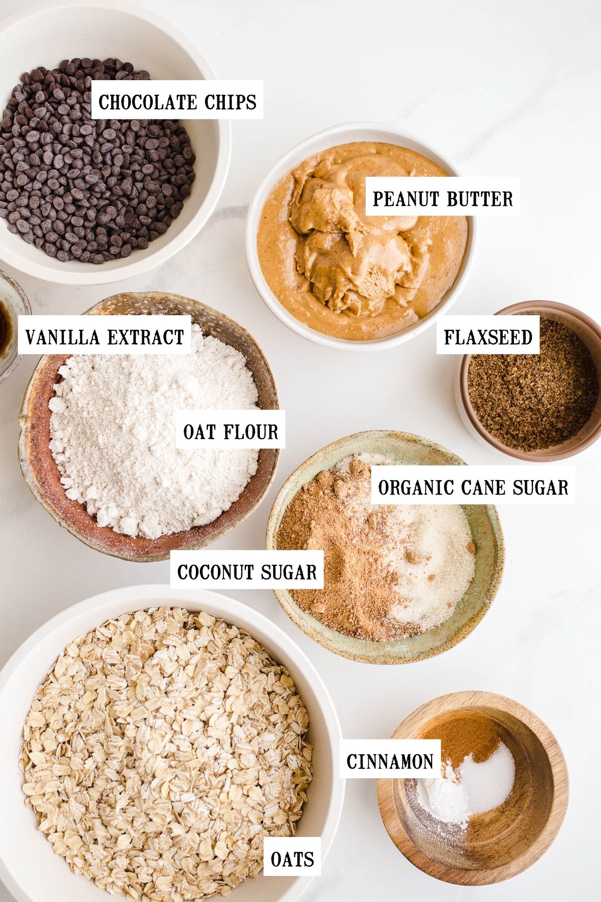 Ingredients to make oatmeal bars with oats in small bowls.