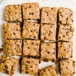 Freshly baked oat bars on parchment paper.