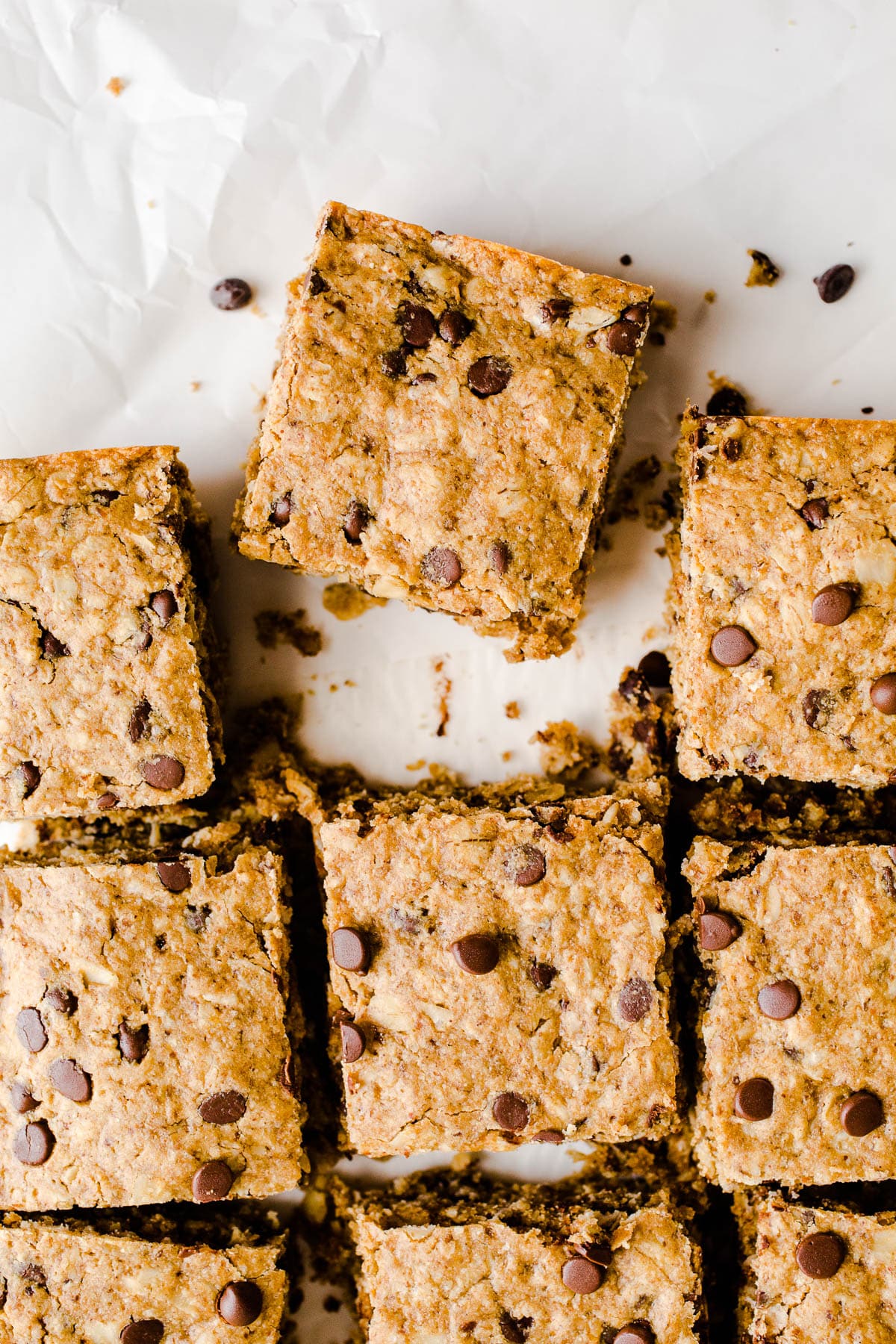 Oat bars with chocolate chips on parchment paper.