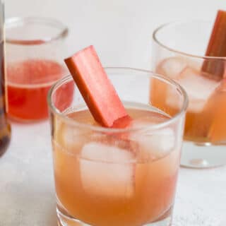 Bourbon sours in cocktail glasses with ice cubes.