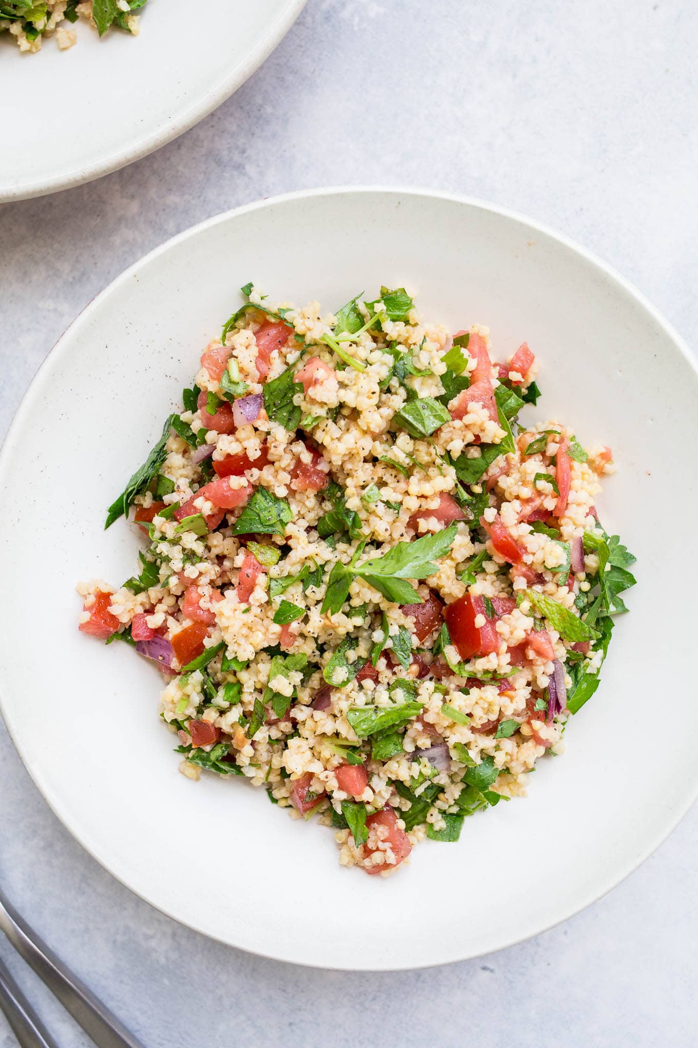 Millet Tabbouleh Salad in a white bowl.