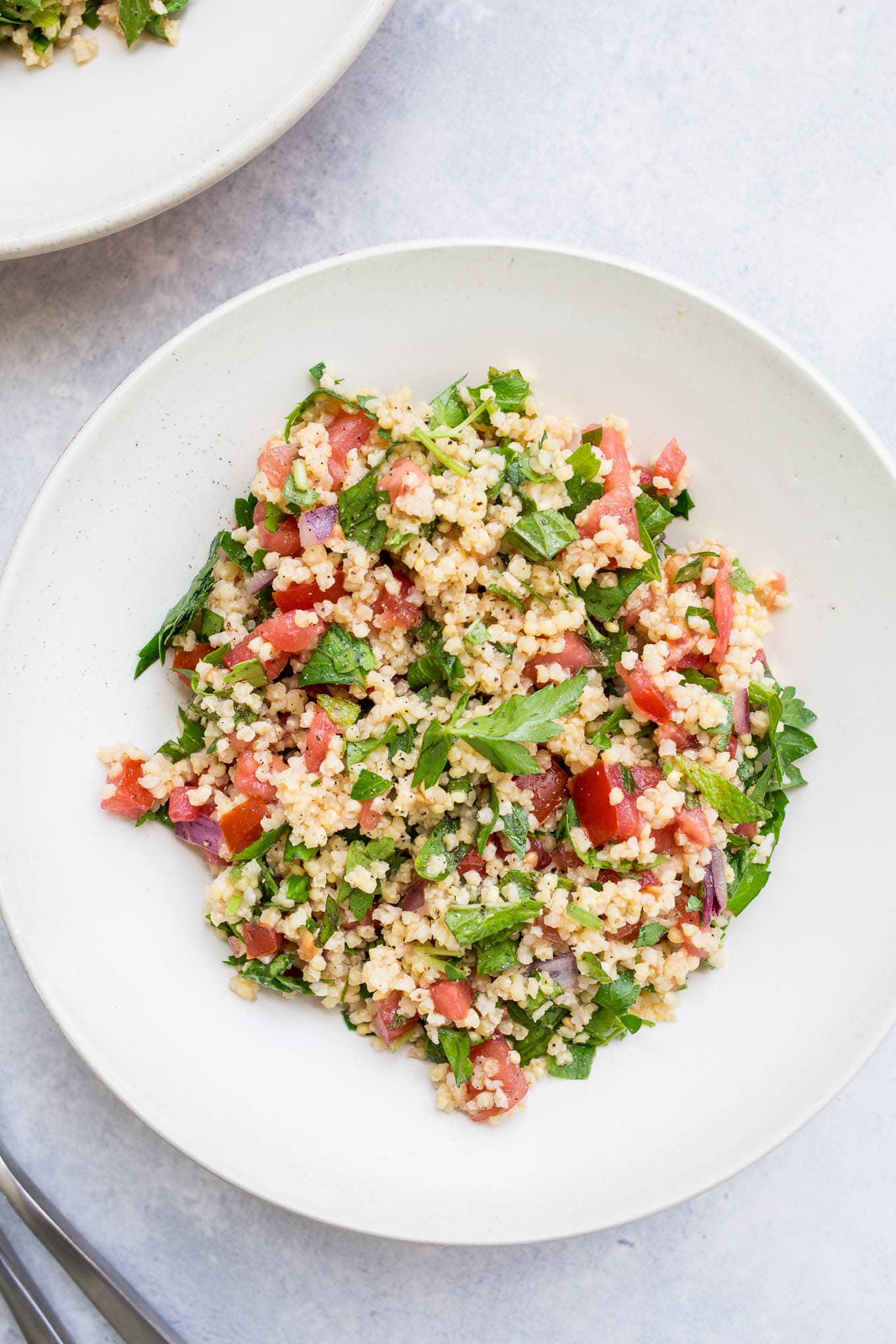 Millet salad in a white bowl. 