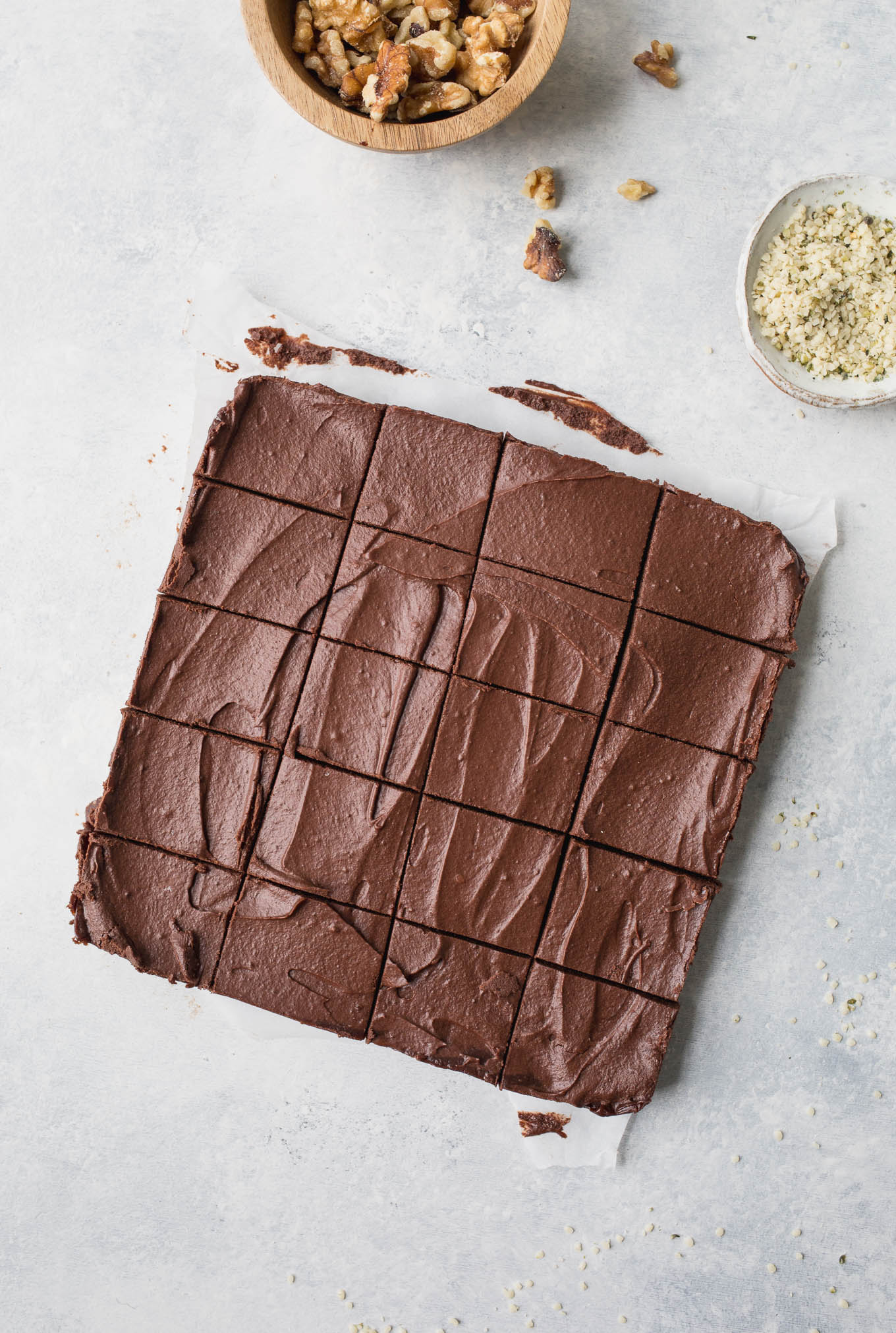 No-bake, raw chocolate brownies made with a layer of hemp seeds, walnuts, cocoa, and dates, topped with a delicious chocolate ganache frosting. Gluten-free, vegan, and refined sugar-free. 
