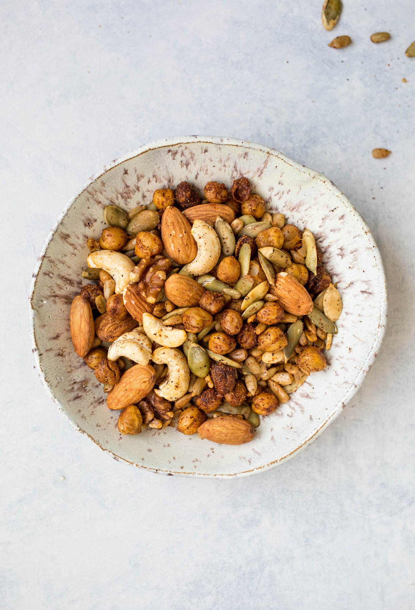 This Spicy Roasted Chickpea Snack Mix is loaded with roasted chickpeas, almonds, cashews, walnuts, pepitas, and sunflower seeds coated with a homemade spicy seasoning mix. Gluten-free, vegan.
