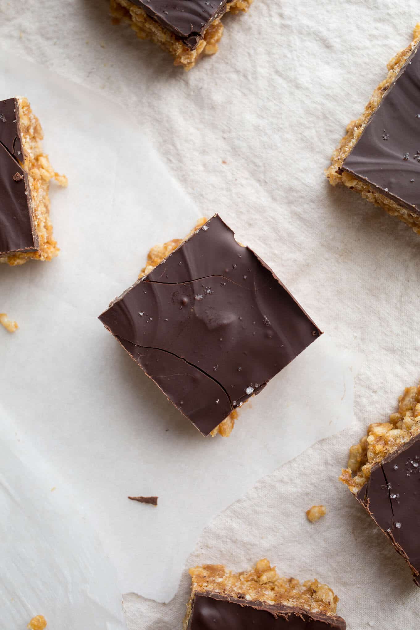 Peanut Butter Maple Scotcheroos are a healthier take on the classic treat. Made with brown rice cereal, peanut butter, maple syrup, and dairy-free chocolate. Gluten-free, vegan, refined sugar-free.