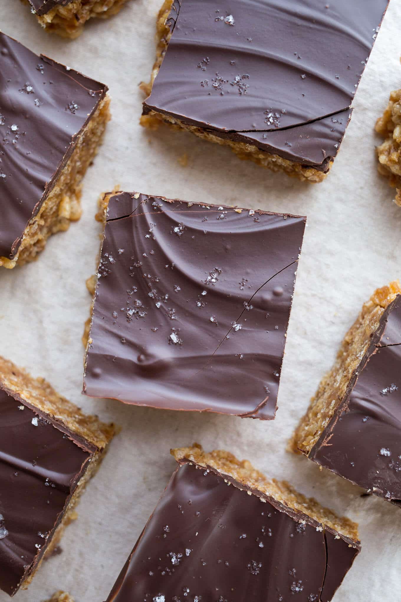 Peanut Butter Maple Scotcheroos are a healthier take on the classic treat. Made with brown rice cereal, peanut butter, maple syrup, and dairy-free chocolate. Gluten-free, vegan, refined sugar-free.