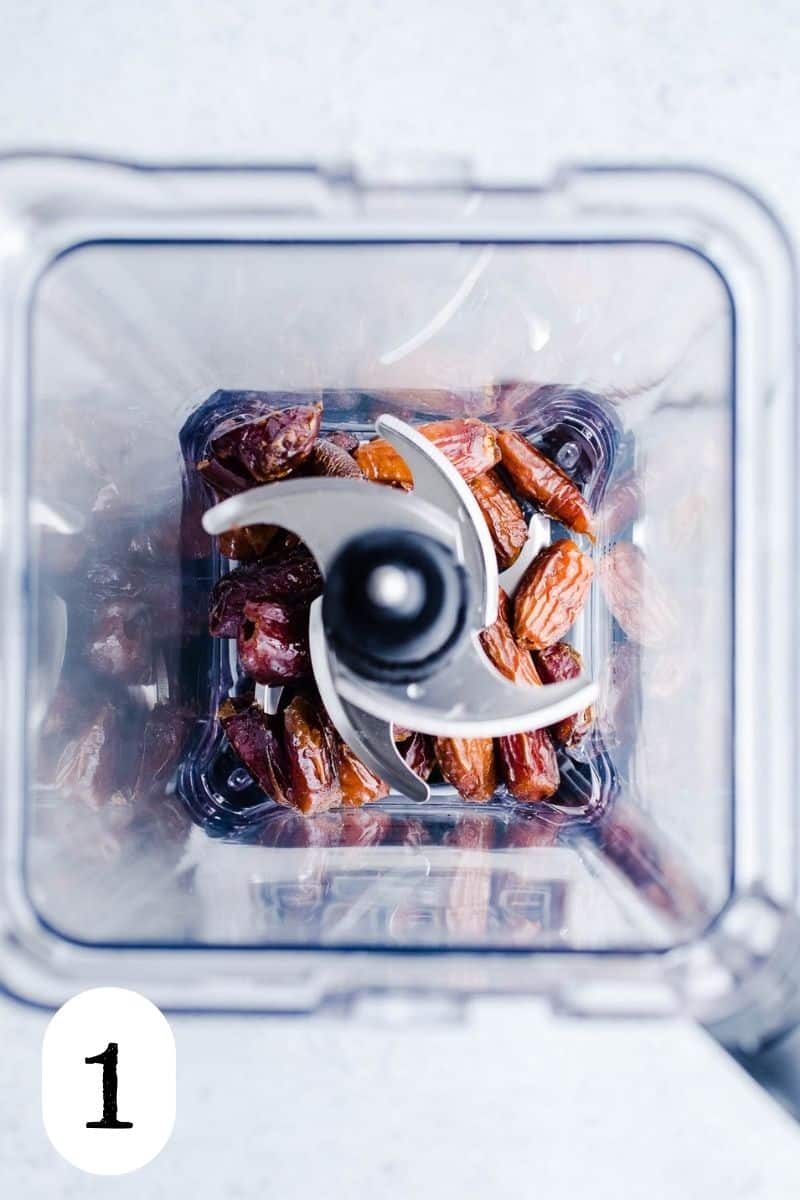 Dates and water in a blender bowl.