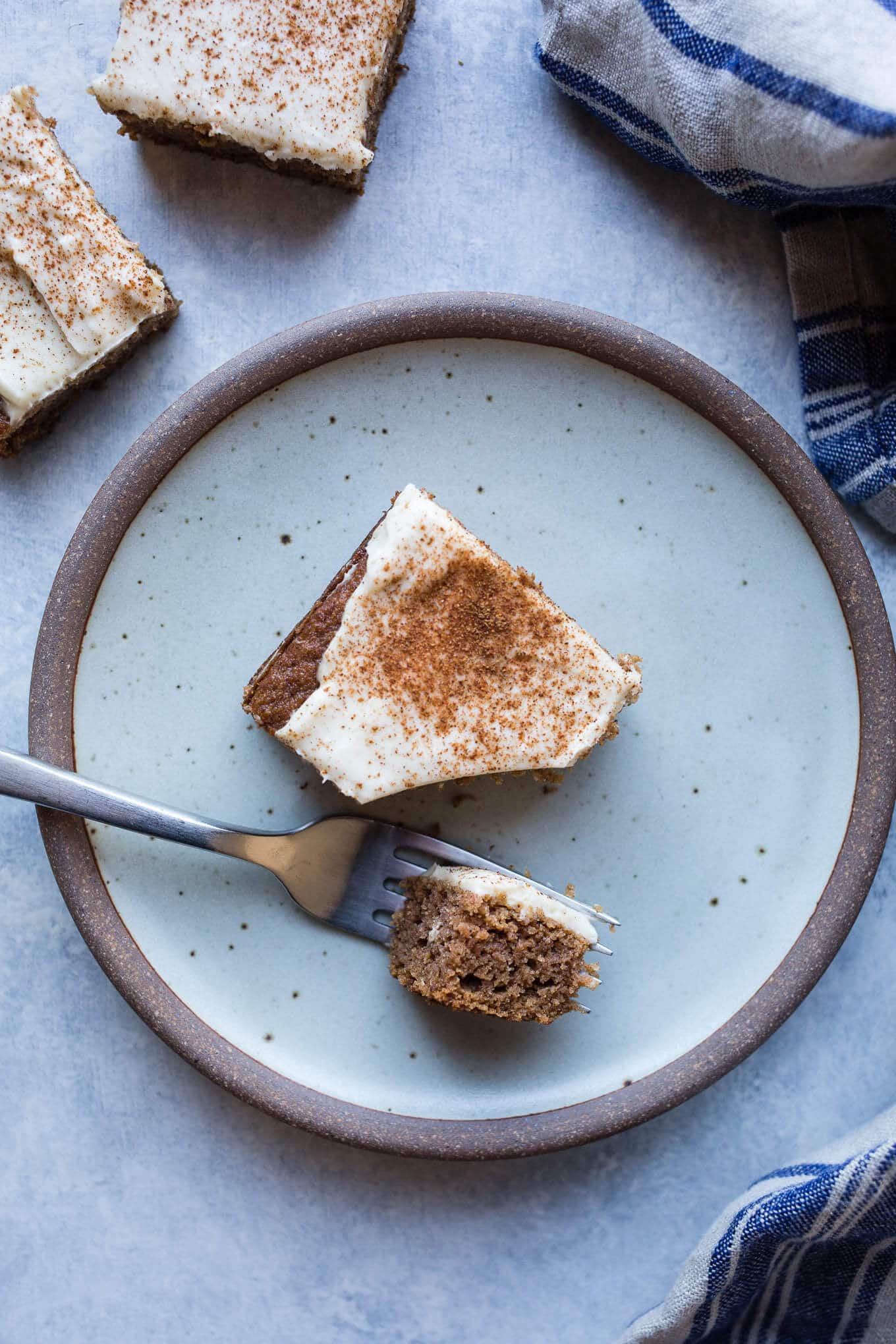 Applesauce Snack Cake made with whole grain oat flour and almond flour, sweetened with coconut sugar, and topped with a maple cream cheese frosting. Gluten-free.