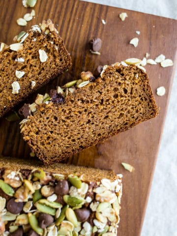 Healthy Sweet Potato Bread made with almond and oat flours, sweetened with maple syrup and sweet potato puree, warming spices, and topped with seeds, nuts, and chocolate chips. Gluten-free, dairy-free.