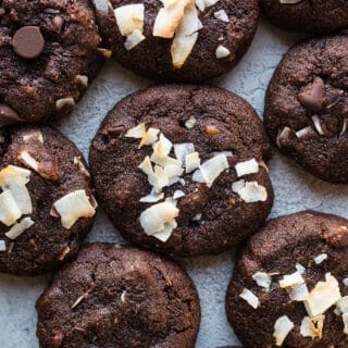 Chocolate cookies crowded on a plate.