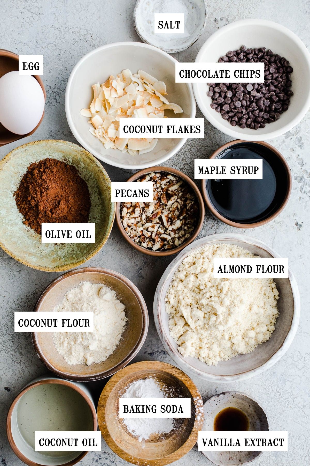 Ingredients to make chocolate cookies in small bowls.