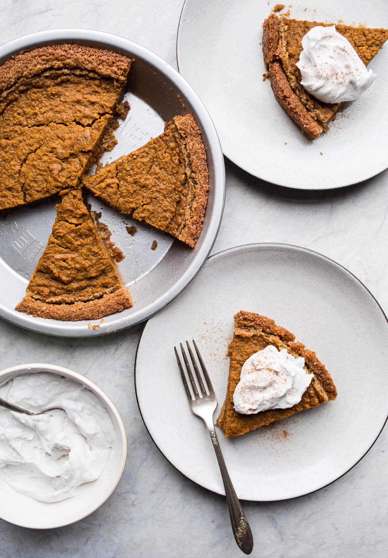 Slices of pumpkin pie on plates. 