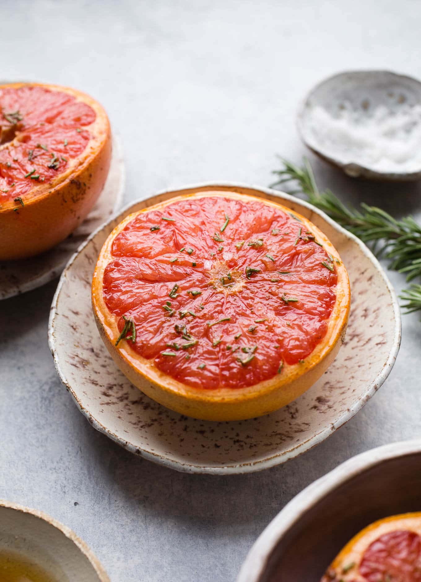 Grapefruit halves topped with maple syrup, cinnamon, rosemary, and a pinch of sea salt make for a delicious sweet and salty breakfast or brunch option. Gluten-free, vegan.