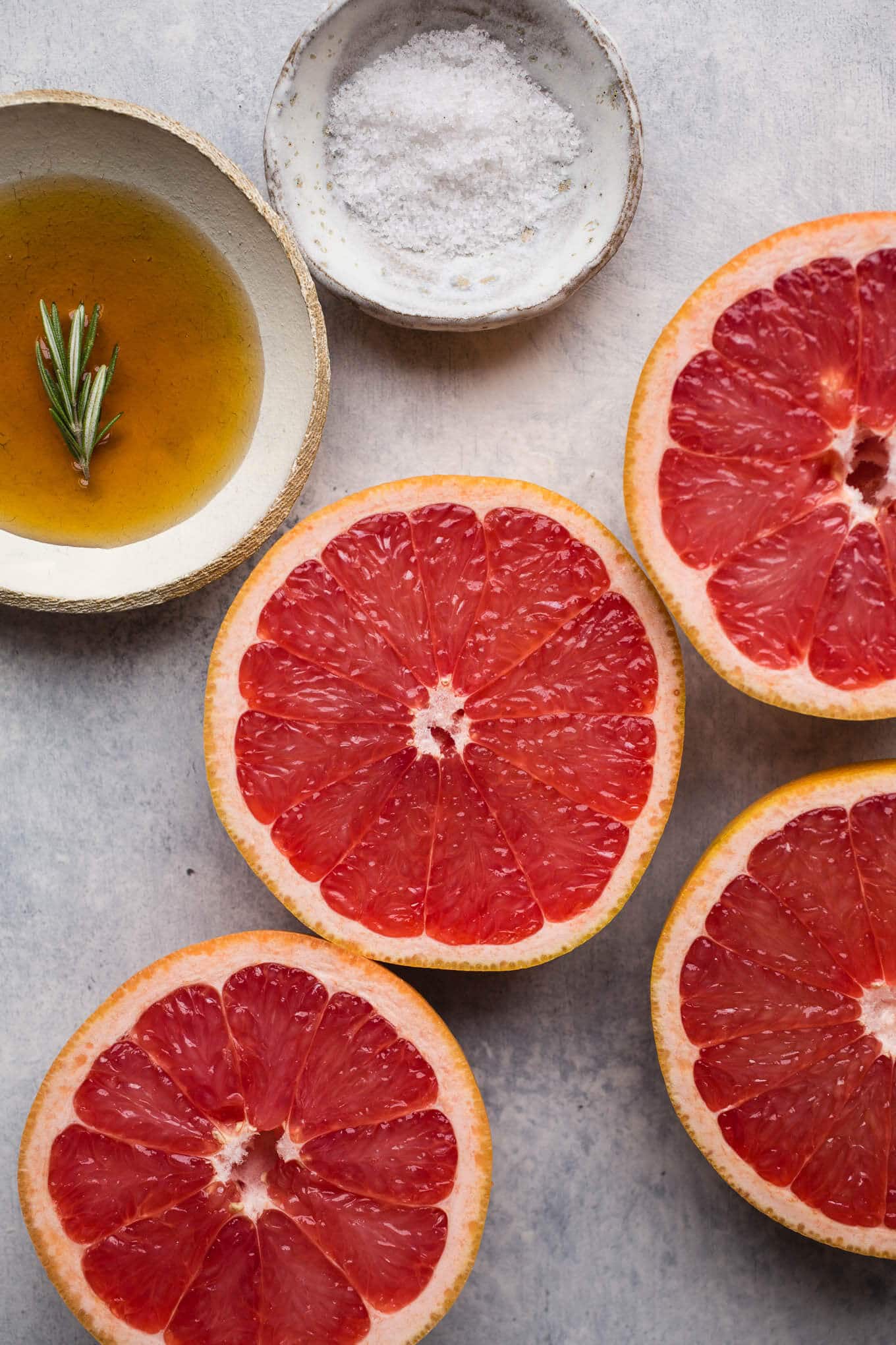 Broiled grapefruit with maple syrup, rosemary, and sea salt make for a delicious sweet and salty breakfast or brunch option. Gluten-free, vegan.