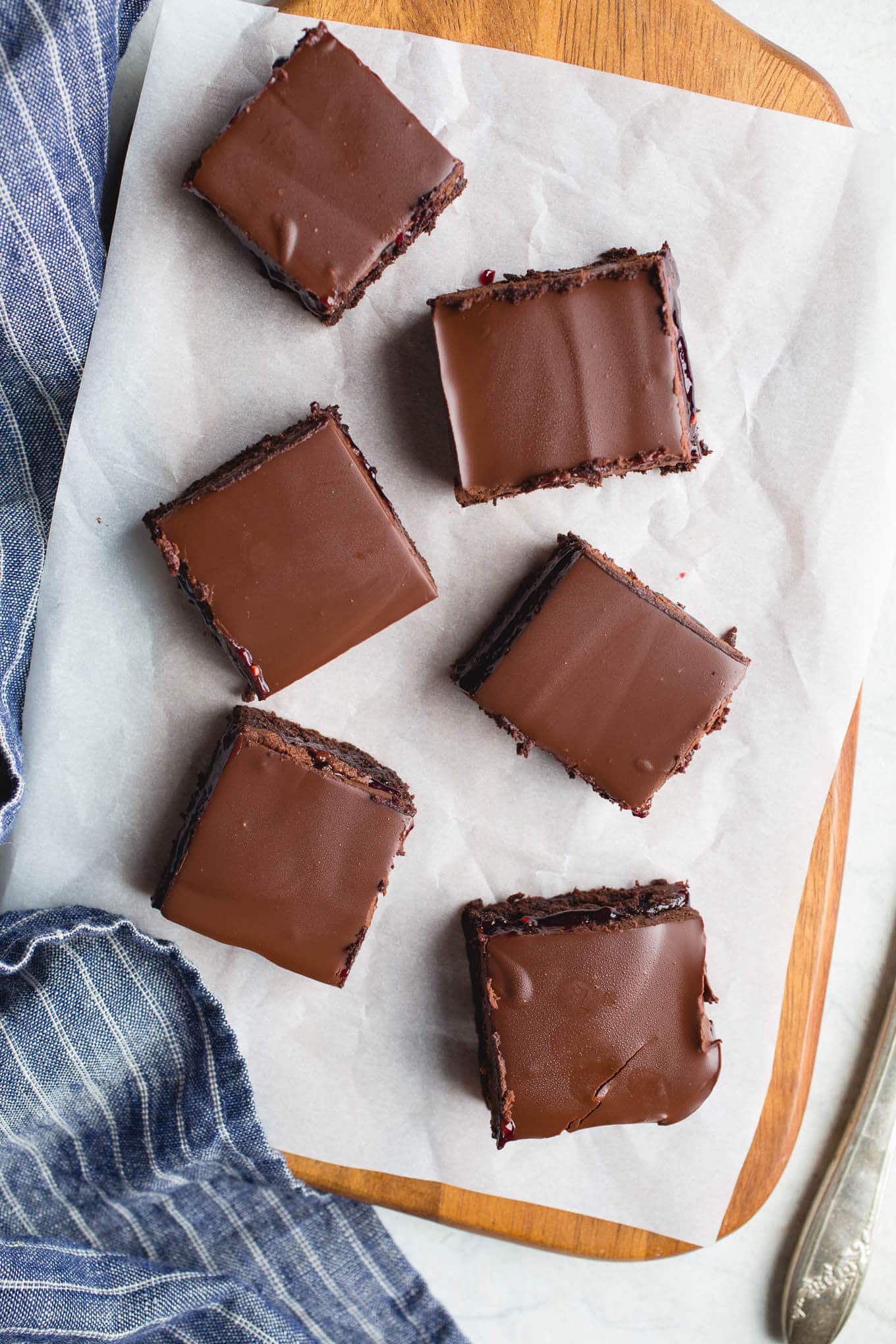 A layer of brownie, a layer of raspberry jam, and a layer of chocolate ganache make up these delicious Raspberry Truffle Brownies. Gluten-Free and dairy-free. 