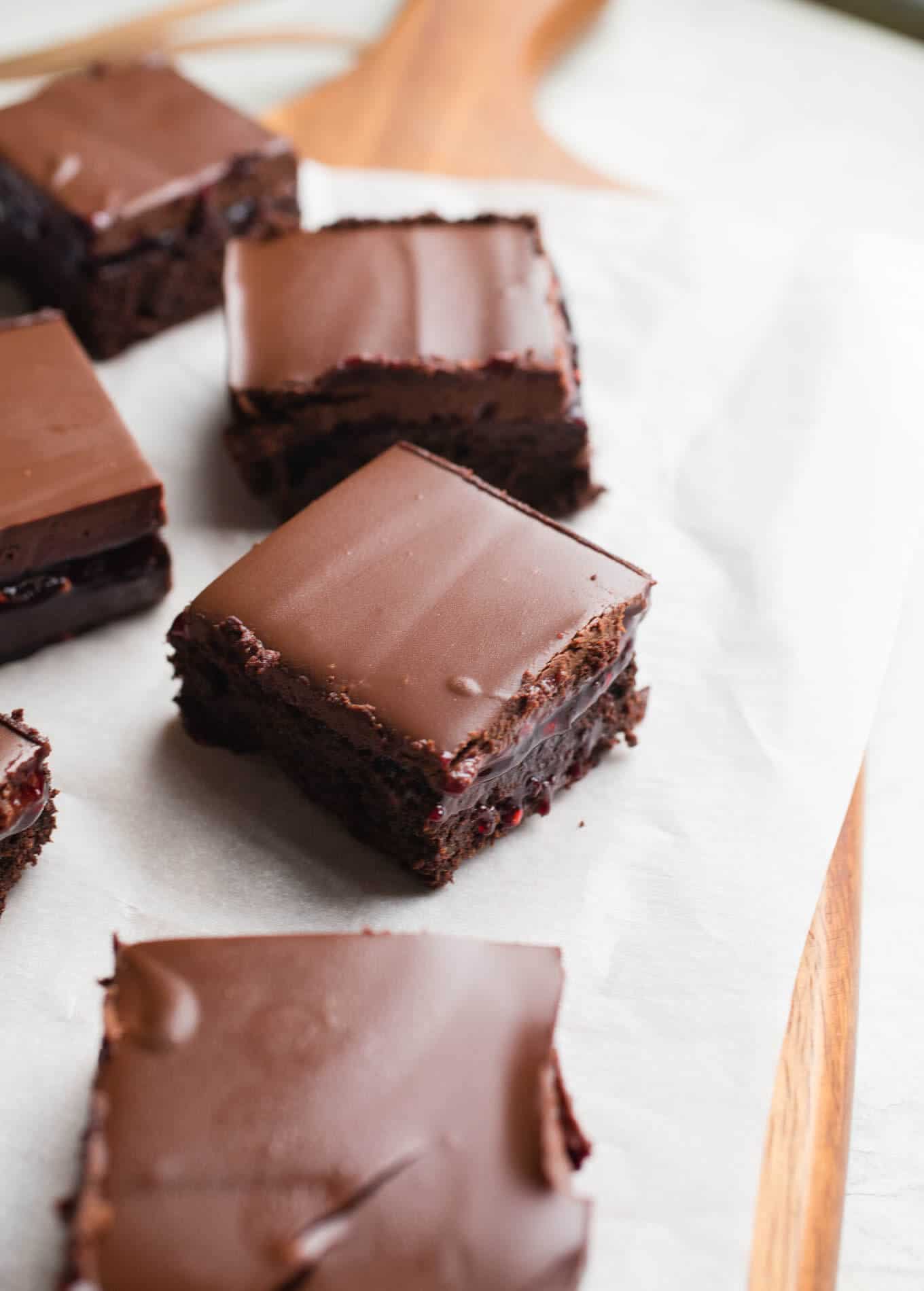 A layer of brownie, a layer of raspberry jam, and a layer of chocolate ganache make up these delicious Raspberry Truffle Brownies. Gluten-Free and dairy-free. 