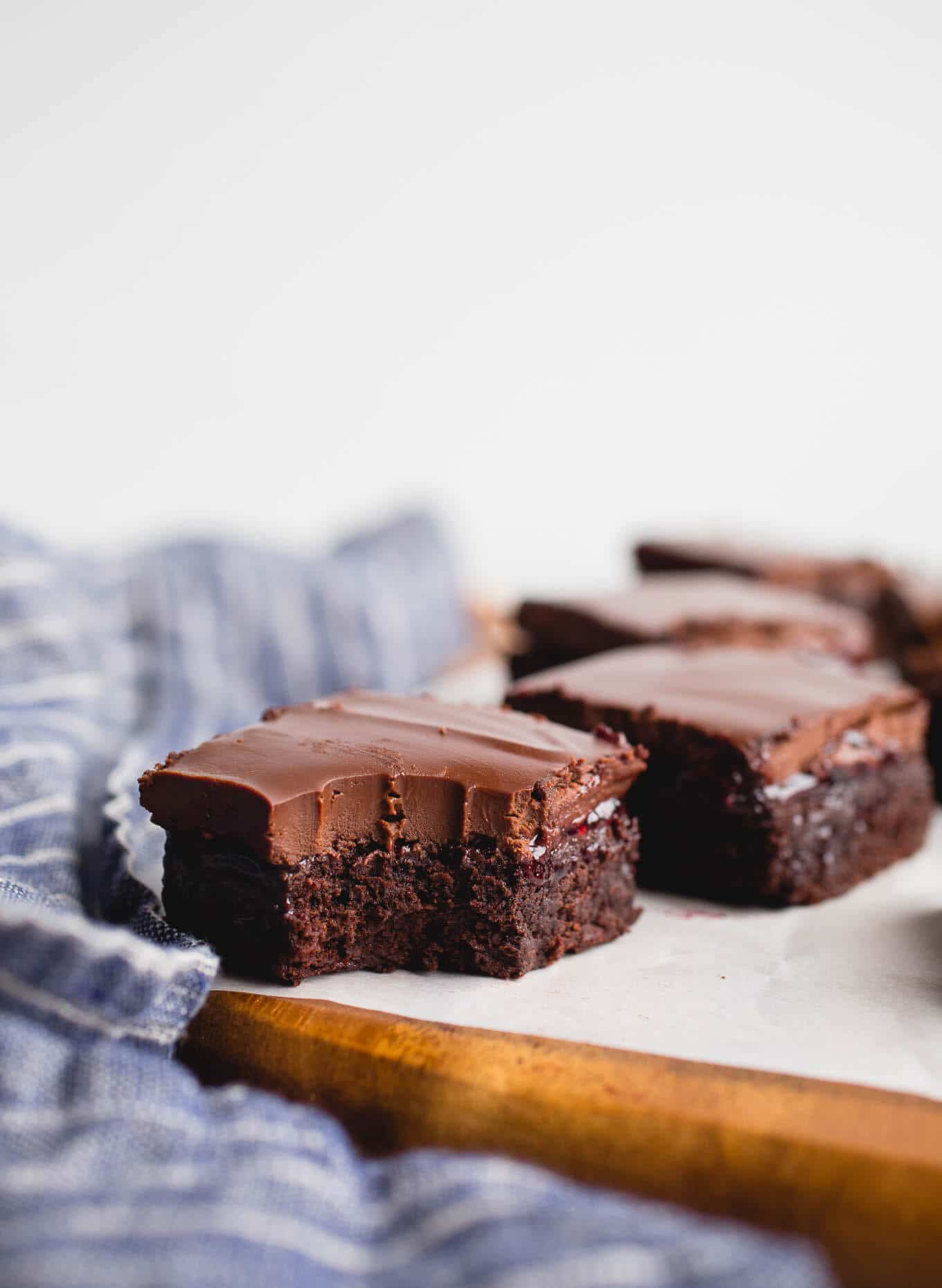 A layer of brownie, a layer of raspberry jam, and a layer of chocolate ganache make up these delicious Raspberry Truffle Brownies. Gluten-Free and dairy-free. 
