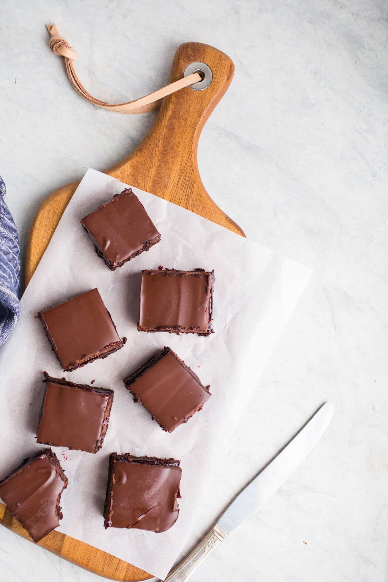 A layer of brownie, a layer of raspberry jam, and a layer of chocolate ganache make up these delicious Raspberry Truffle Brownies. Gluten-Free and dairy-free. 