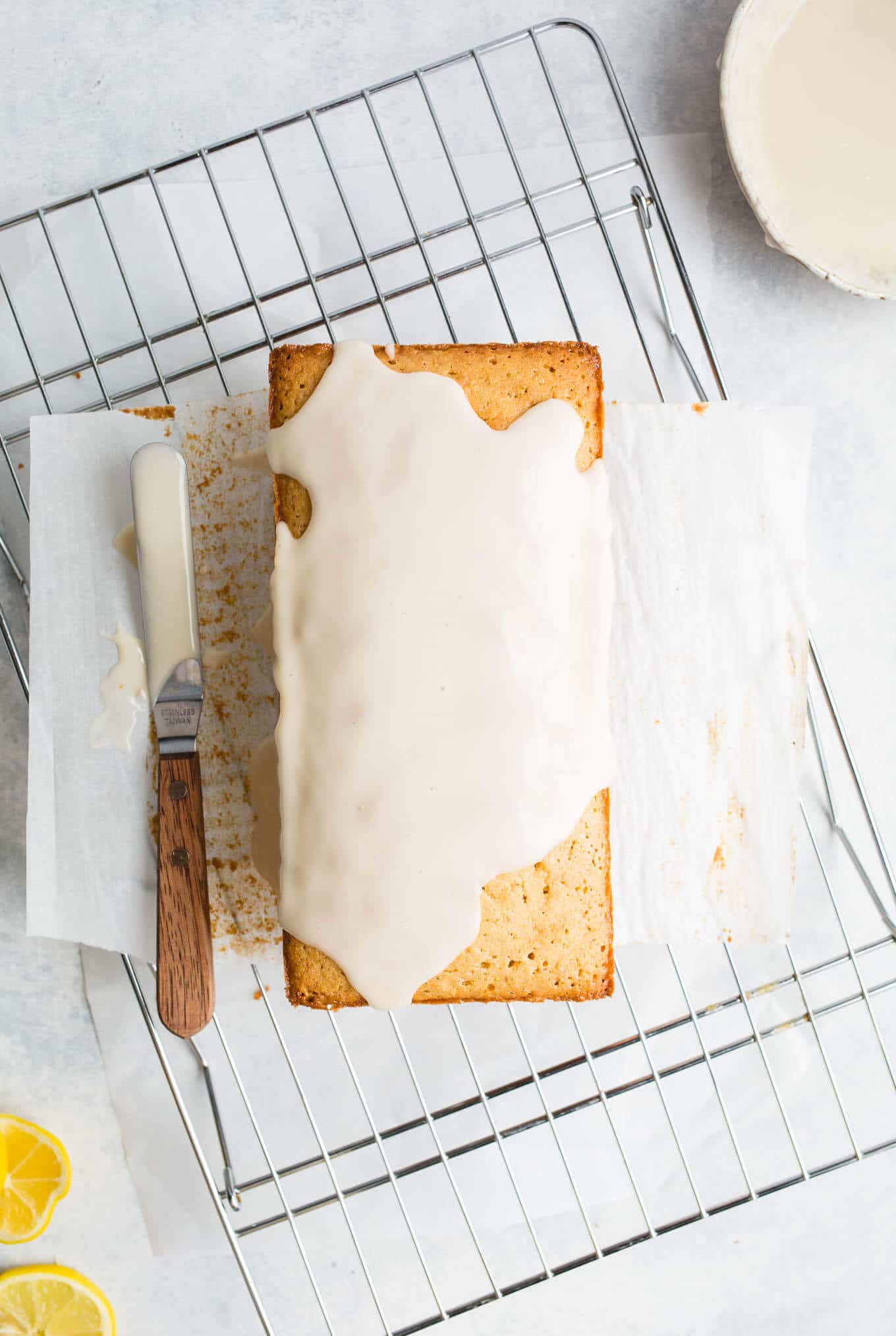 An iced pound cake on a wire rack.