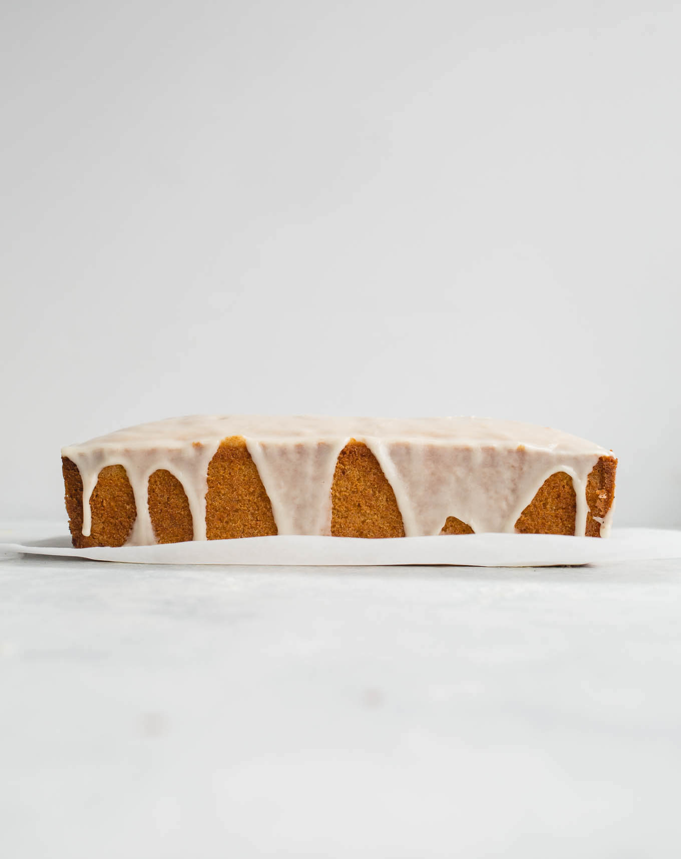 Gluten-Free Iced Lemon Pound Cake made from almond flour, white rice flour, and cornstarch, fresh lemon juice and lemon zest, and coated in a lemon icing glaze. Sweet, tart, and delicious. Gluten-free, dairy-free. 