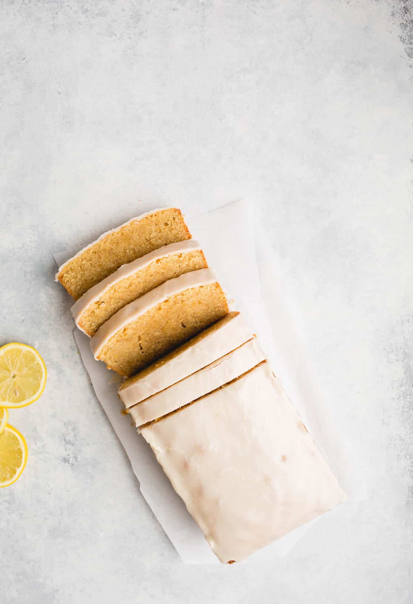 Gluten-Free Iced Lemon Pound Cake made from almond flour, white rice flour, and cornstarch, fresh lemon juice and lemon zest, and coated in a lemon icing glaze. Sweet, tart, and delicious. Gluten-free, dairy-free. 