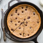 Salted Tahini Chocolate Chip Cookie Skillet is a an easy one-bowl recipe made with almond four, tahini, maple syrup, and studded with chocolate chips. Gluten-free, vegan, refined sugar-free.