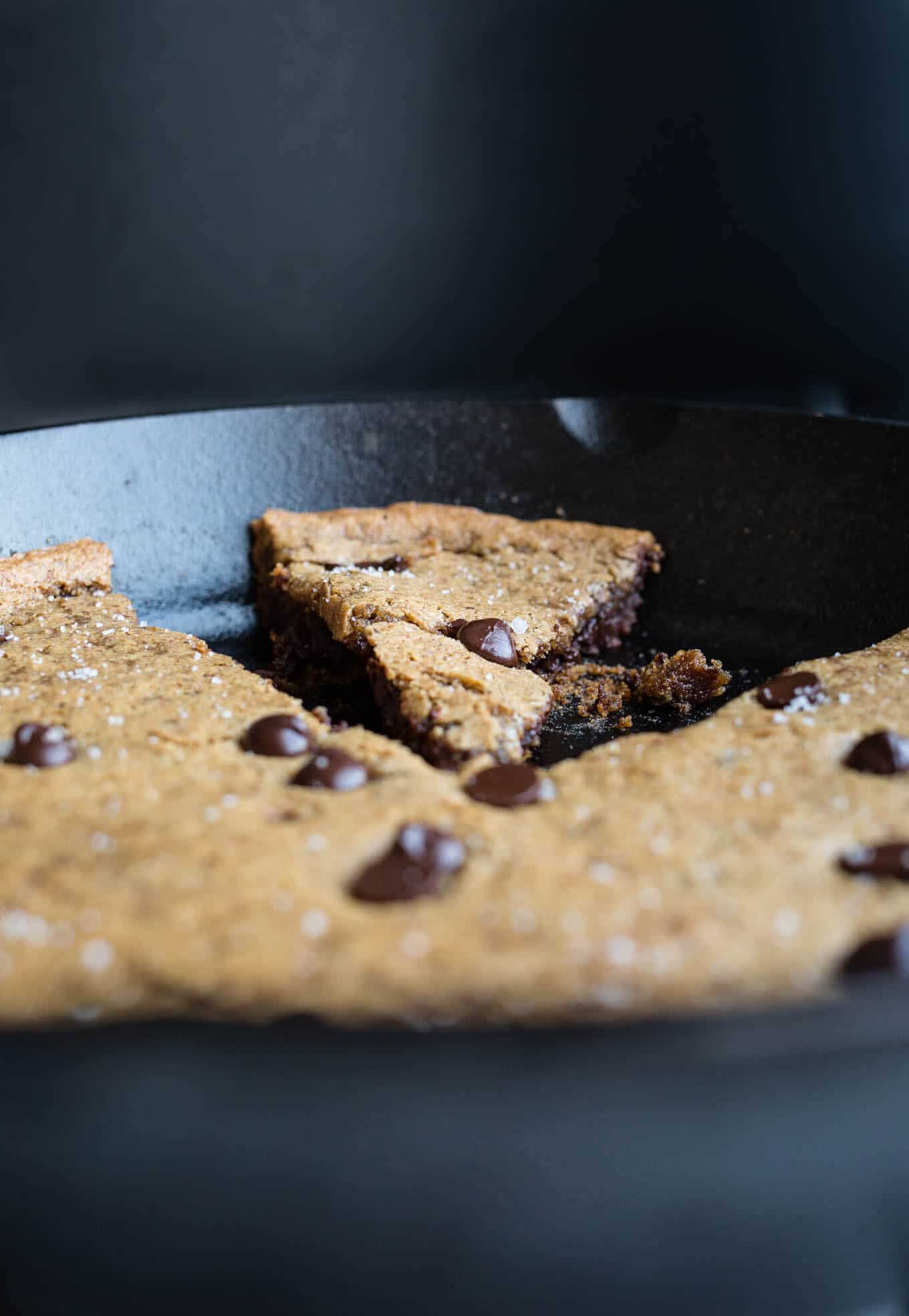 Salted Tahini Chocolate Chip Cookie Skillet is a an easy one-bowl recipe made with almond four, tahini, maple syrup, and studded with chocolate chips. Gluten-free, vegan, refined sugar-free. 
