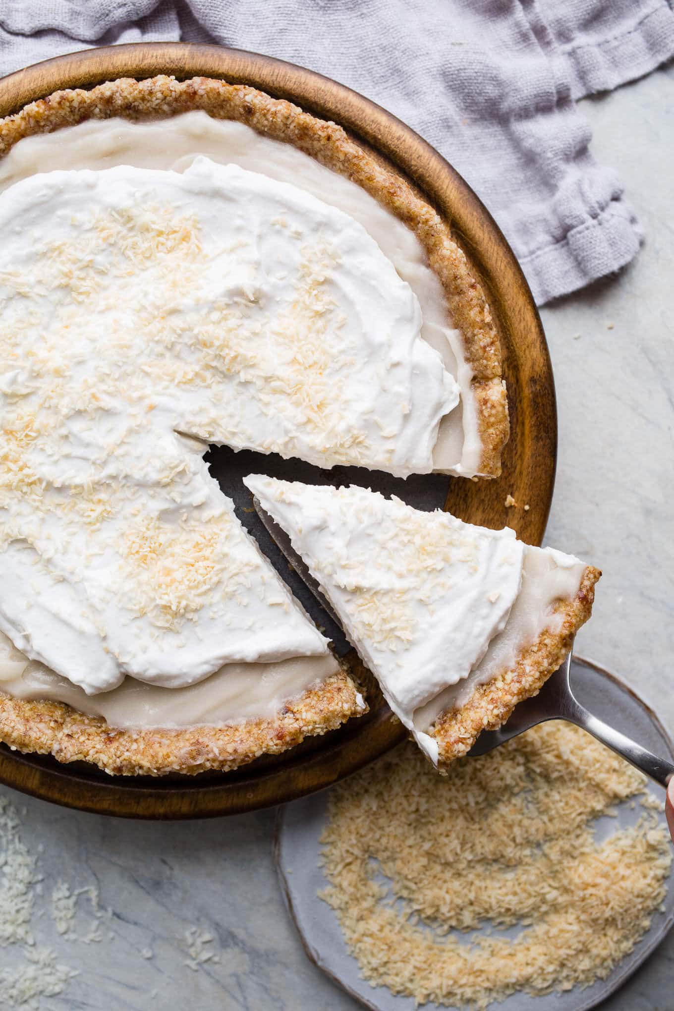 This No-Bake Coconut Cream Pie is made with a sprouted almond press-in crust, coconut milk pudding filling, and topped coconut cream and toasted shredded coconut. Gluten-free, vegan.