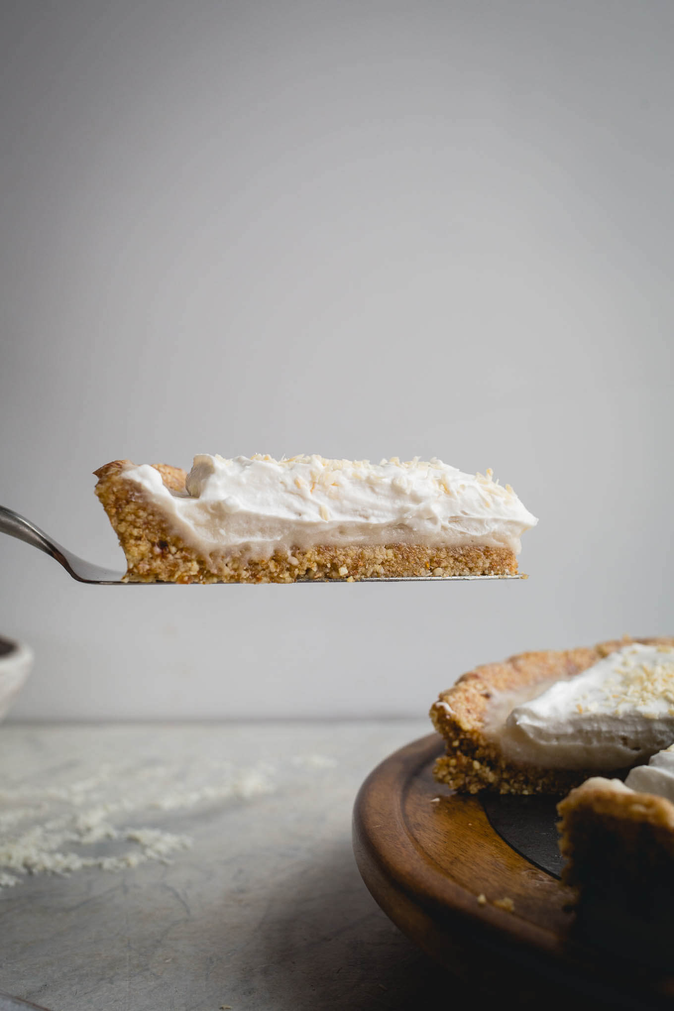 This No-Bake Coconut Cream Pie is made with a sprouted almond press-in crust, coconut milk pudding filling, and topped coconut cream and toasted shredded coconut. Gluten-free, vegan.