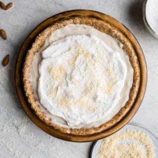 This No-Bake Coconut Cream Pie is made with a sprouted almond press-in crust, coconut milk pudding filling, and topped coconut cream and toasted shredded coconut. Gluten-free, vegan.