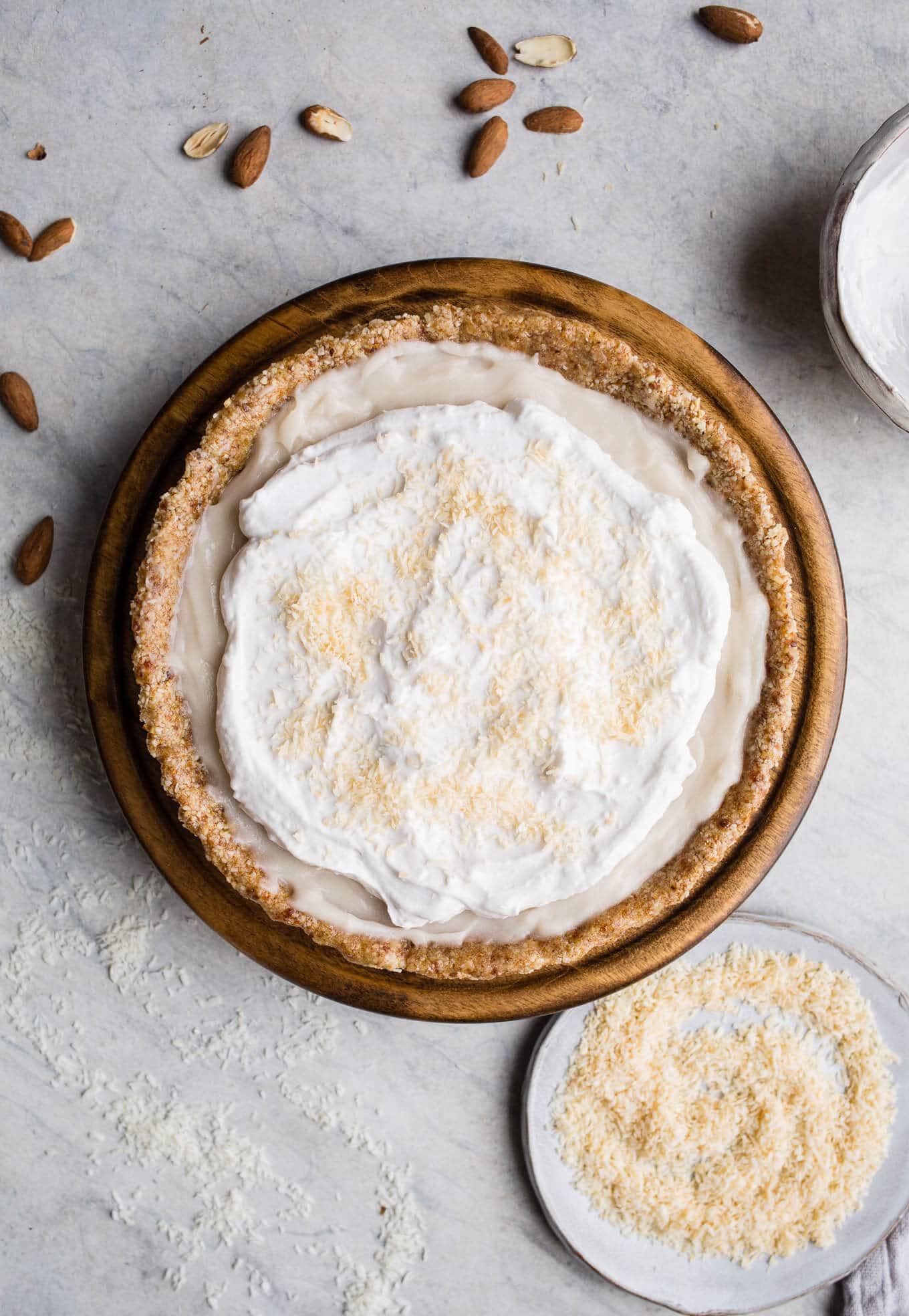 This No-Bake Coconut Cream Pie is made with a sprouted almond press-in crust, coconut milk pudding filling, and topped coconut cream and toasted shredded coconut. Gluten-free, vegan.